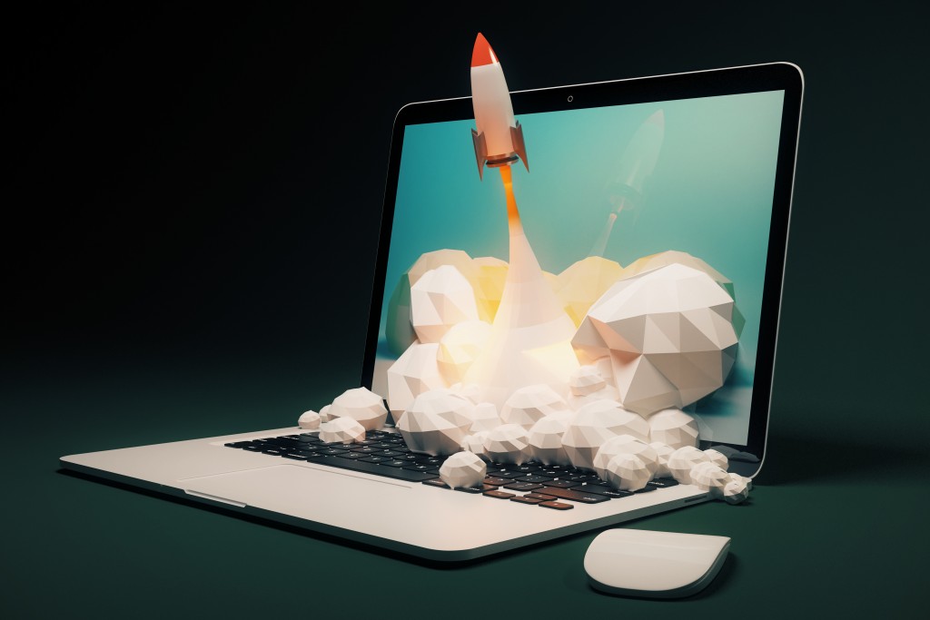 digital marketing metaphor with rocket and laptop
