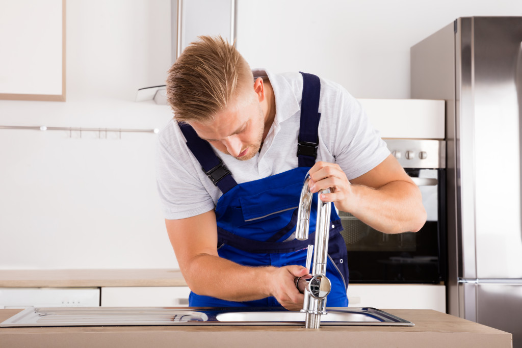 man fixing the faucet