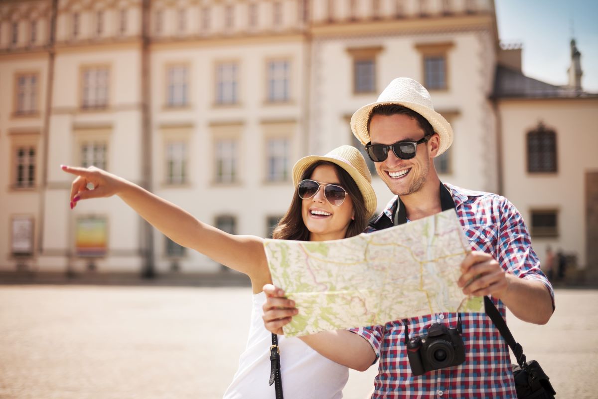 tourist couple holding map