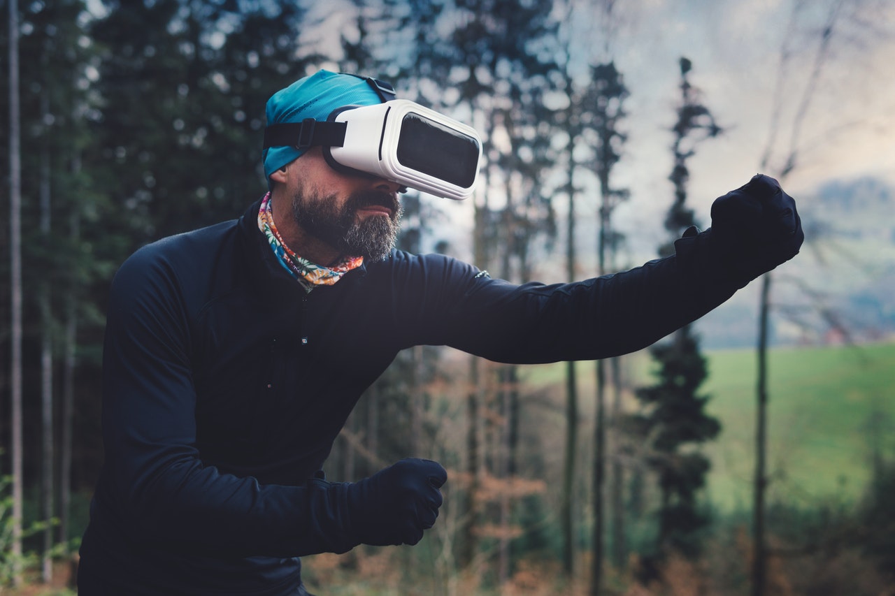 man playing with vr headset outdoors