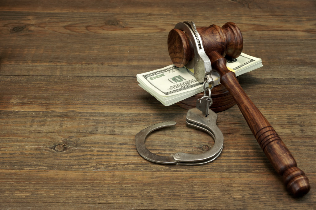 gavel, handcuffs, and cash