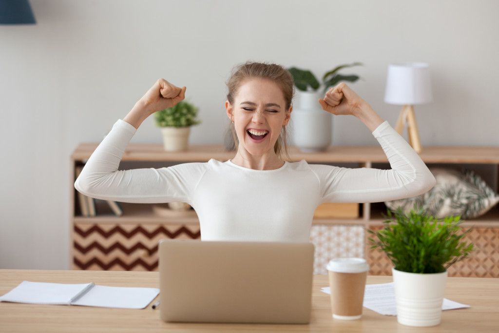 white American woman rejoicing while working