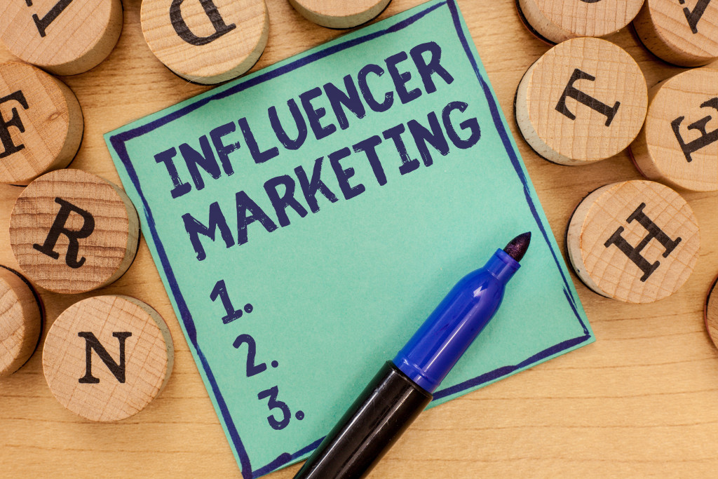 influencer marketing written by sharpie in a blue green paper