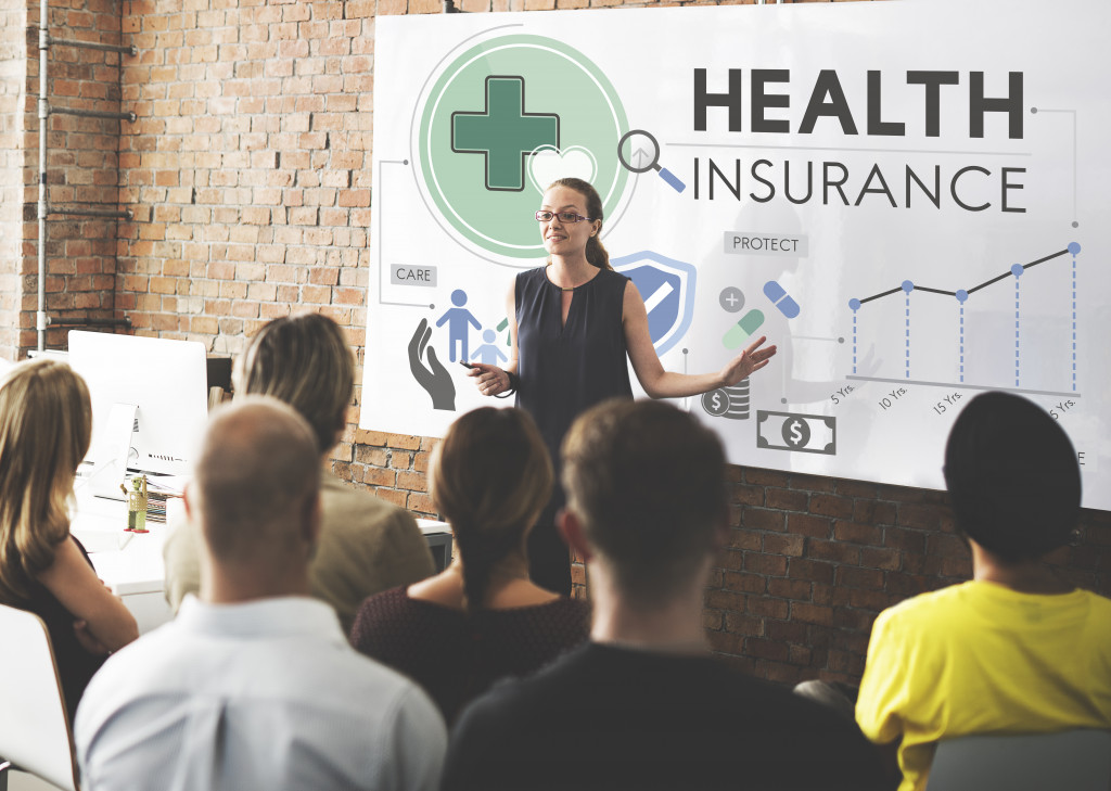 a woman discussing health insurance among employees