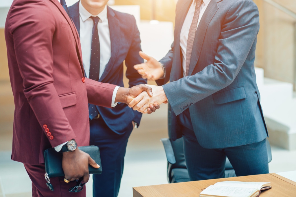 Businessmen shaking hands during a business meeting in an office