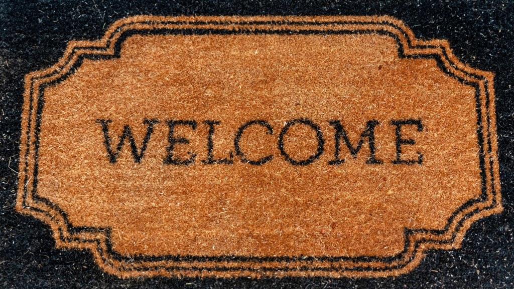 Rectangular black and brown doormat with the word Welcome at the center
