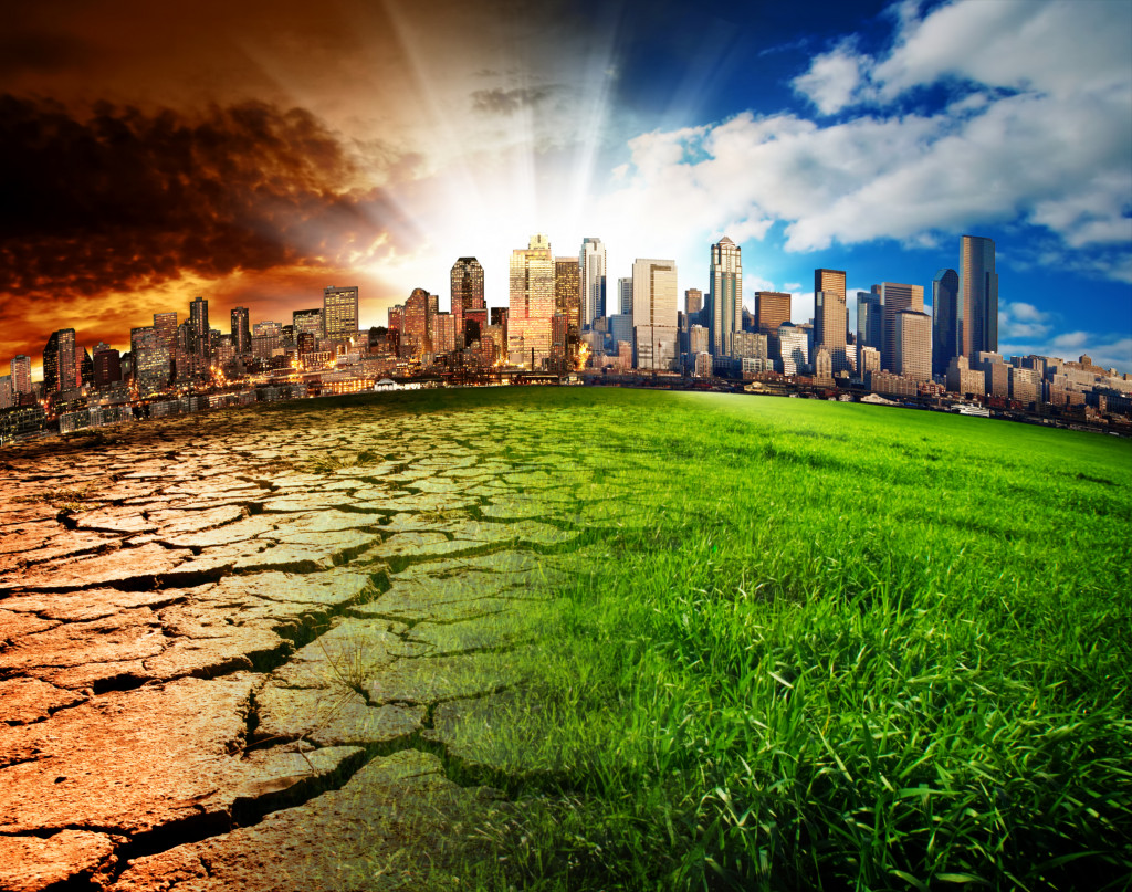 Cracked land showing the effects of climate change with a city skyline in the background.