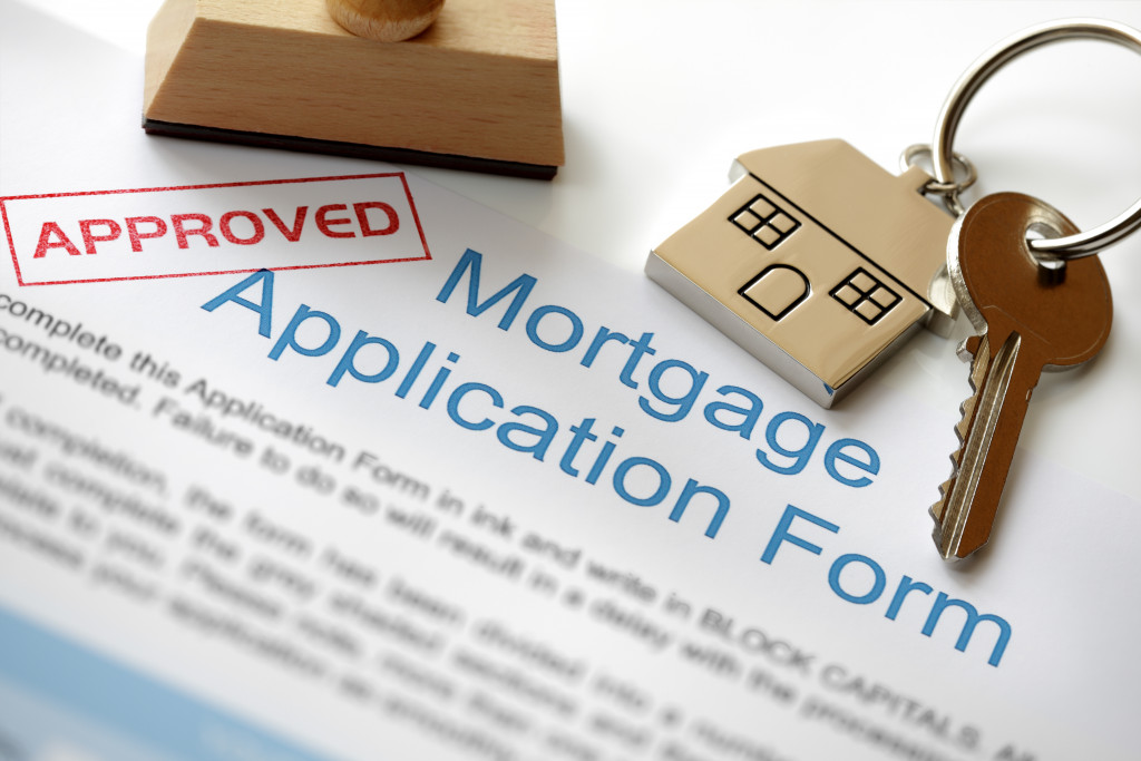 An approved mortgage loan application with a key and stamp on top