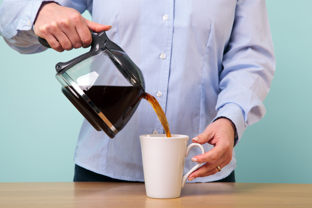 An employee pouring coffee