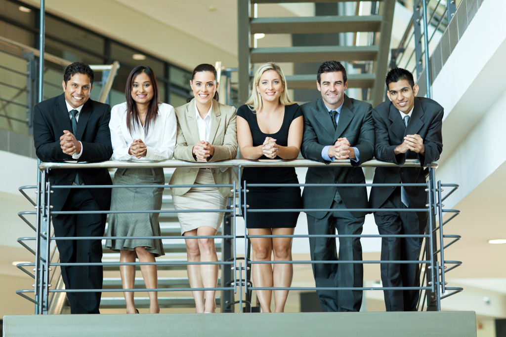 a team of employees by the stairs of the office