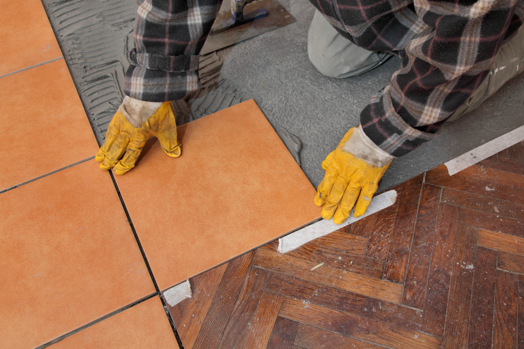contractor repairing flooring and tiles