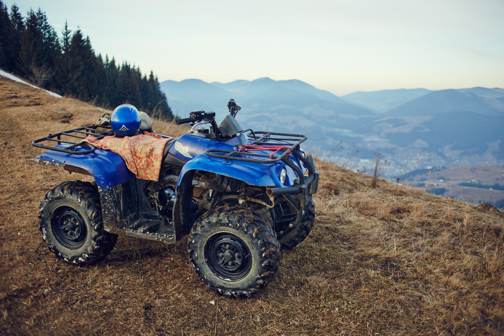 Blue ATV on the side of a mountain.